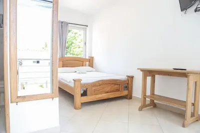 a bedroom with a bed and a mirror at Hotel Caribe Coveñas in Coveñas