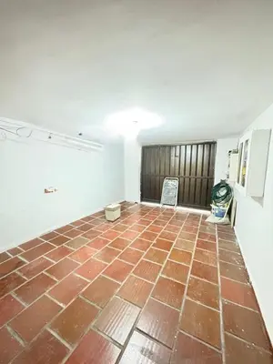 an empty room with a brick floor in a house at Casa Ciudad Jardin Centro Histórico in Barranquilla