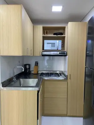 a small kitchen with a sink and a microwave at Apartamento de Lujo, amoblado en Cartagena in Cartagena de Indias