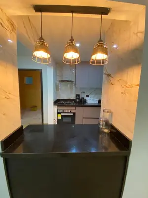a kitchen with a black counter top and lights at YOLO solo se vive una vez - MORROS Cartagena in Cartagena de Indias