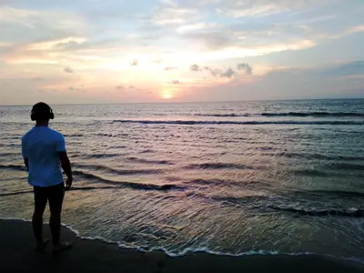 a person standing on the beach watching the sunset at Casa MAR de FE in Cartagena de Indias