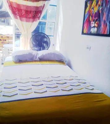 a bed in a room with a window at Casa MAR de FE in Cartagena de Indias