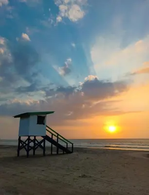 a lifeguard stand on the beach at sunset at Casa MAR de FE in Cartagena de Indias