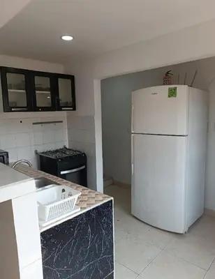 a kitchen with a white refrigerator and a stove at Hermoso apartamento in Cartagena de Indias