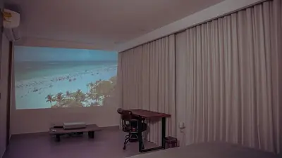 a bedroom with a large window with a view of a beach at Villa Karibana Paradise in Cartagena de Indias
