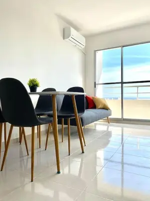 a dining room with a table and chairs and a couch at Apartamento en Cartagena in Cartagena de Indias