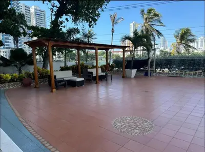 a pavillion with a wooden pavilion and palm trees at Amazing Ocean View apartment with Pool in Laguito Cartagena in Cartagena de Indias