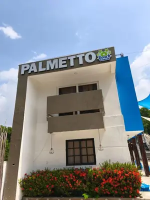 a palmetto gas station with a sign on it at Hotel Palmetto Beach Coveñas in Coveñas