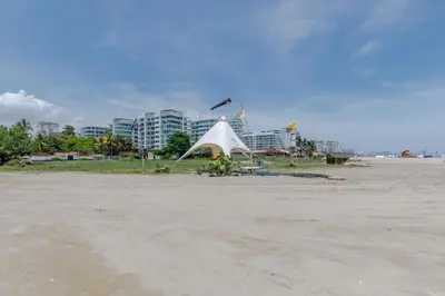 a white tent on the beach with a building in the background at Apartamento de lujo en Cartagena Seaway935 - Morros in Cartagena de Indias