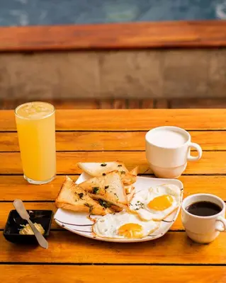 a plate of eggs and toast and a glass of orange juice at Hb5 Family Room with private bathroom facing the sea in Cartagena de Indias