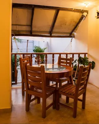 a dining room table and chairs with a glass top at Hb7 Quadruple Room with shared bathroom in Cartagena de Indias
