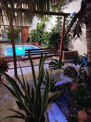 a resort with a pool and a bunch of plants at Hb7 Quadruple Room with shared bathroom in Cartagena de Indias