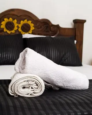 a towel sitting on top of a bed at Beach House In La Boquilla Facing the Sea With Air Conditioning and WIFI in Cartagena de Indias