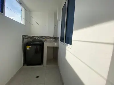 a small kitchen with a stove and a table in a room at lindo Apartamento completo in Cartagena de Indias