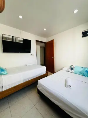 a bedroom with two beds and a flat screen tv at APTO 802 VISTA AL MAR in Cartagena de Indias