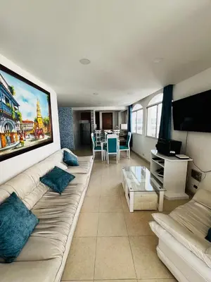 a living room with a white couch and a tv at APTO 802 VISTA AL MAR in Cartagena de Indias