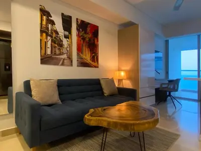 a living room with a couch and a wooden coffee table at Wynwood Cartagena Beach in Cartagena de Indias