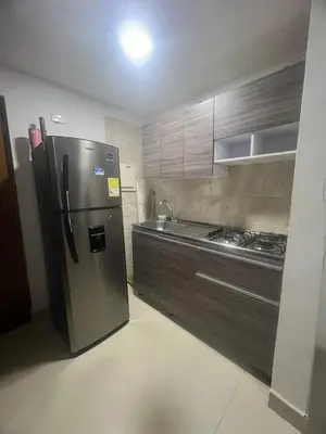 a kitchen with a stainless steel refrigerator and cabinets at A un paso del mar in Cartagena de Indias