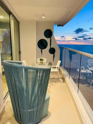 a balcony with a table and chairs and a view of the ocean at 2-2 Palmetto Eliptic 3403 Enchanted Jewel in Cartagena de Indias