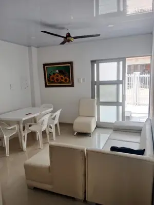 a living room with a couch and a table and chairs at Summer - Apartamento Sector La Coquerita in Coveñas