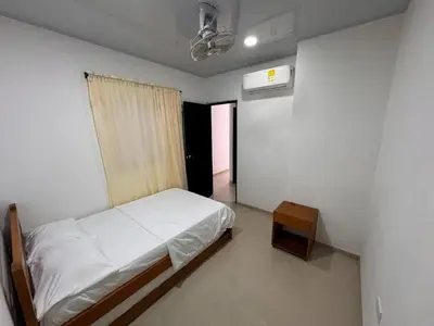 a bedroom with a bed and a table in it at Summer - Apartamento Sector La Coquerita in Coveñas