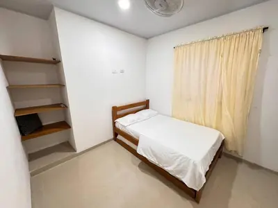 a small bedroom with a bed and a window at Summer - Apartamento Sector La Coquerita in Coveñas