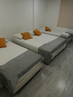 a group of three beds in a room at Hotel Doral Barranquilla in Barranquilla