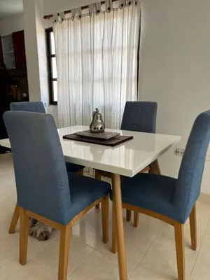 a dining room table with blue chairs and a tea kettle on it at Northwest Hostings 201 in Cartagena de Indias