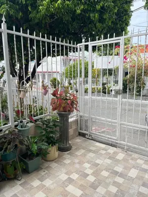 a white fence with potted plants on a patio at Northwest Hostings 201 in Cartagena de Indias
