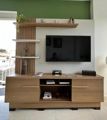 a wooden entertainment center with a flat screen tv at Northwest Hostings 201 in Cartagena de Indias