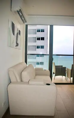 a living room with a white couch in front of a window at Apartamento nuevo en cartagena en el cabrero in Cartagena de Indias