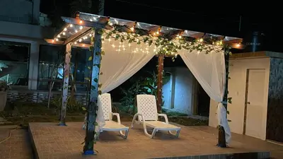 a gazebo with two chairs and lights at Cabaña Villa Linda in Juan de Acosta