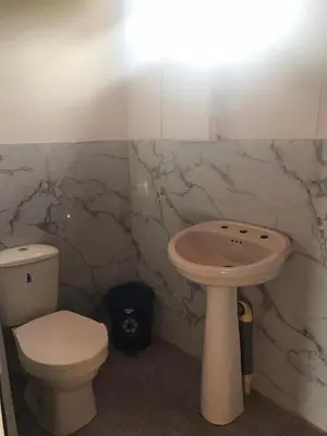 a bathroom with a toilet and a sink at HOSTAL LAMAR BARU dónde Gertrudis in Playa Blanca
