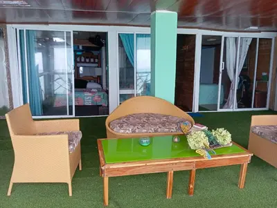 a room with two chairs and a table with a couch at HOSTAL LAMAR BARU dónde Gertrudis in Playa Blanca