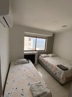 a bedroom with two beds and a window at APTO DUPLEX MARINA DEL REY CARTAGENA in Cartagena de Indias