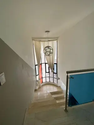 a hallway with a staircase with a large window at APTO DUPLEX MARINA DEL REY CARTAGENA in Cartagena de Indias