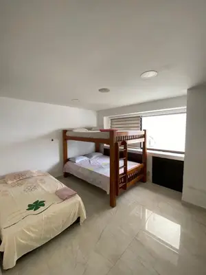 a bedroom with two bunk beds and a window at APTO DUPLEX MARINA DEL REY CARTAGENA in Cartagena de Indias