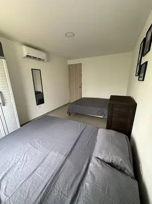 a bedroom with two beds in a room with a bed at Apto PB Palmar de los vientos in San Bernardo del Viento