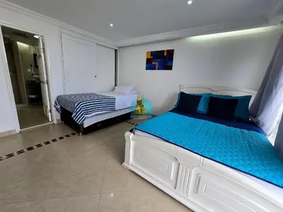 a bedroom with a large bed and a bed sqor at Penthouse Duplex Vista 360 Piso 23 in Cartagena de Indias