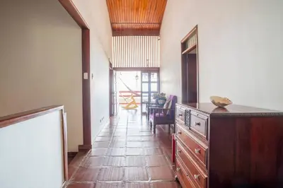 a hallway with a kitchen with a counter and a table at El Refugio Beach House, Bello Horizonte, Santa Marta in Playa Dormida