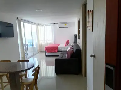 a living room with a couch and a bed and a table at Apto 1715 in Cartagena de Indias
