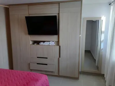 a bedroom with a entertainment center with a flat screen tv at Apto 1715 in Cartagena de Indias