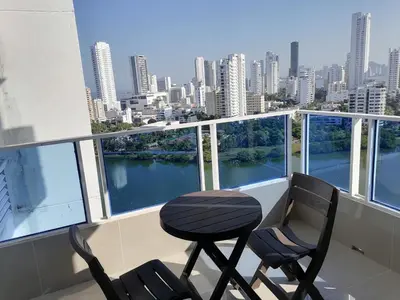 a balcony with two chairs and a view of a city at Apto 1715 in Cartagena de Indias