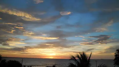 a sunset over the ocean with a cloudy sky at Villa Patry Coveñas in Coveñas