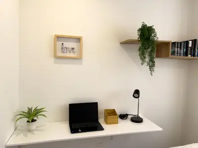 a desk with a laptop on a white wall at Lujoso apartamento cerca al Aeropuerto y Ciudad Amurallada in Cartagena de Indias