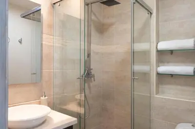 a bathroom with a shower with a sink and a toilet at Sunshine 503 Beautiful SeaView 2Beds2bath w AC front Beach in Cartagena de Indias