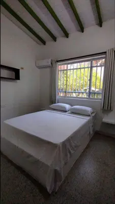 a large bed in a room with a window at Atardeceres Coveñas - Cabañas frente al mar in Puerto Viejo