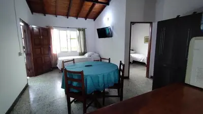 a room with a table with a blue table cloth at Atardeceres Coveñas - Cabañas frente al mar in Puerto Viejo