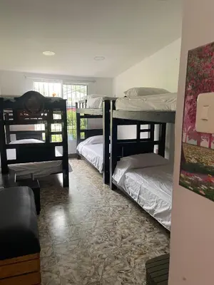 a room with three bunk beds and a couch at La casa de flor in Cartagena de Indias