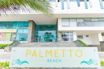 a sign for palmetto beach in front of a building at U-GO Palmetto Beach - Lujo Frente al Mar in Cartagena de Indias